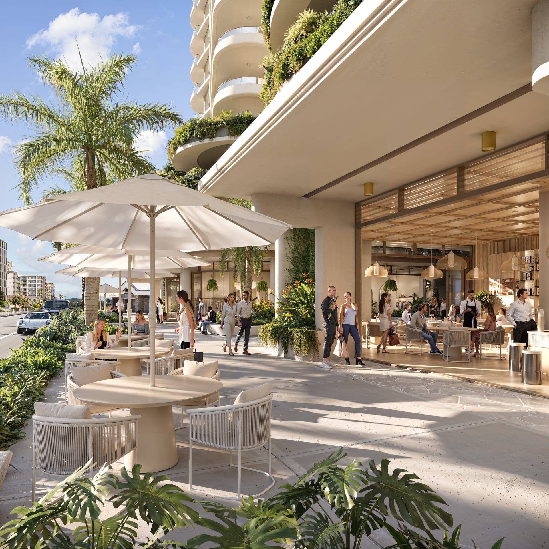 Soleira ground-floor retail at street level, with outdoor cafe seating beneath the tower